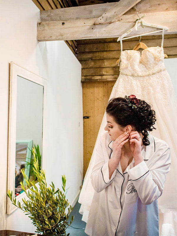 Bride getting ready at a rustic barn wedding in Hampshire